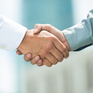 Close-up image of a firm handshake standing for a trusted partnership